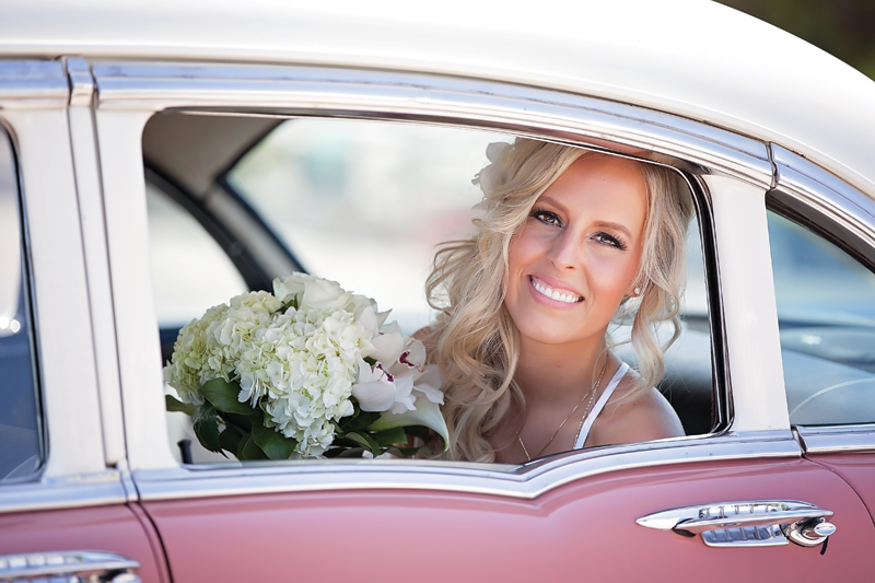 Bride with bouquet in car 